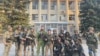 Ukrainian troops pose for a photo in Lyman, Ukraine in this picture released in social media, Oct. 1, 2022.