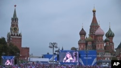 People attend celebration for the annexation of regions of Ukraine to join Russia, in Red Square in Moscow, Russia, Sept. 30, 2022.