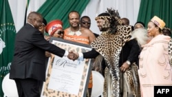 King Misuzulu Zulu, 48, receives the certifcate of recognition from South African President Cyiril Ramaphosa during the kings coronation at the Moses Mabhida Stadium in Durban, Oct. 29, 2022.