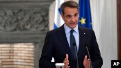 Greek Prime Minister Kyriakos Mitsotakis talks to the media during a press conference after a meeting with German Chancellor Olaf Scholz (not pictured), at Maximos Mansion in Athens, Oct. 27, 2022. 