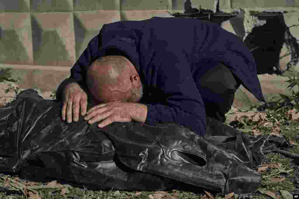 A man reacts near the body of his cousin, killed in a Russian rocket attack in Mykolaiv, Ukraine.