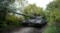 FILE - Ukrainian servicemen drive a T-80 tank that they said had been captured from the Russian army, in Bakhmut, Ukraine, Oct. 2, 2022. 