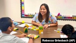 Lety Vargas, a newly hired English Language teacher at Russellville Elementary School coaches students, Aug. 9, 2022. (Rebecca Griesbach/AL.com via AP)