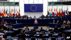 European Commission President Ursula von der Leyen, center, speaks during a commission on Russia's escalation of its war of aggression against Ukraine, at the European Parliament, Wednesday, Oct. 5, 2022, in Strasbourg, eastern France. (AP Photo/Jean-Fran