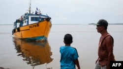 Fishermen drive their boat to safety ahead of Hurricane Julia's arrival in the Bluefields port, Nicaragua, on Oct. 8, 2022.