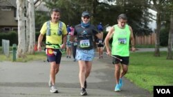 Visually-impaired runner with running guide from United in Stride