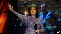 FILE - Loretta Lynn waves to the crowd after performing during the Americana Music Honors and Awards show, Sept. 17, 2014, in Nashville, Tennessee. 