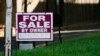 FILE - A 'for sale by owner' sign is displayed outside home in Northbrook, Ill., Sept. 21, 2022. 