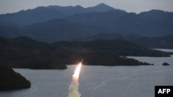 FILE - This undated photo released from the Korean Central News Agency on Oct. 10, 2022, shows a missile launch training by the Korean People's Army Tactical Nuclear Operation Unit from an undisclosed area. On Tuesday, North Korea fired artillery shells into the coastal waters. 