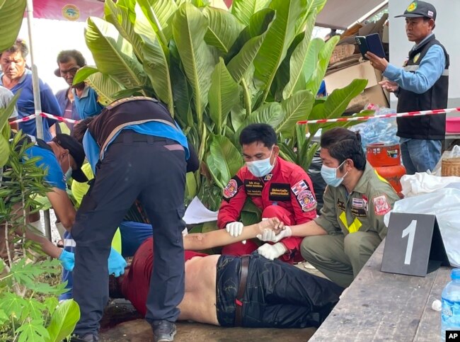 Emergency workers attend to a victim at the site of an attack at a childcare center, Oct. 6, 2022, in the town of Nongbua Lamphu, north eastern Thailand. (Mungkorn Sriboonreung Rescue Group via AP)