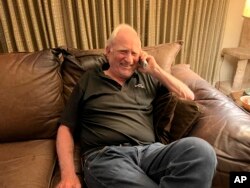 John F. Clauser speaks to reporters on the phone at his home in Walnut Creek, Calif., on Tuesday, Oct. 4, 2022. (AP Photo/Terry Chea)