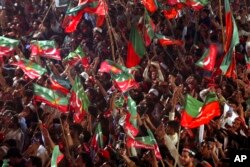 FILE - Supporters of Pakistani opposition leader Imran Khan's Tehreek-e-Insaf party attend a rally, in Peshawar, Pakistan, Sept. 6, 2022.