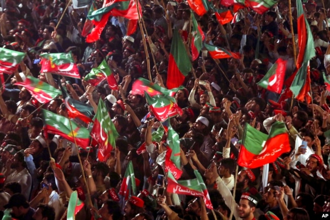 FILE - Supporters of Pakistani opposition leader Imran Khan's Tehreek-e-Insaf party attend a rally, in Peshawar, Pakistan, Sept. 6, 2022.