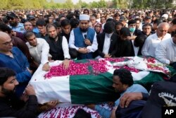 FILE - People attend the funeral prayer of slain senior Pakistani journalist Arshad Sharif, in Islamabad, Oct. 27, 2022.
