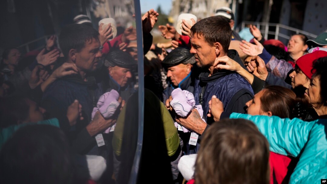 Locals receive food and everyday necessities given by Ukrainian volunteers in Izium, Ukraine, Oct. 12, 2022. Residents in Izium have been living with no gas, electricity or running water supply since beginning of September.