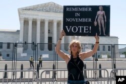 FILE - Nicky Sundt, of Washington, protests outside of the Supreme Court, June 29, 2022, in Washington. (AP Photo/Jacquelyn Martin, File)