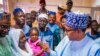 In this photo released by the Nigeria State House, Nigeria's President Muhammadu Buhari, right, meets with freed train hostages in Kaduna Nigeria, Oct. 6, 2022. (Bayo Omoboriowo/Nigeria State House via AP)