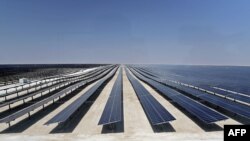 This picture taken on October 18, 2022 shows a view of solar panels at the newly-inaugurated al-Kharsaah solar power plant in Qatar. 