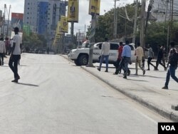 Orang-orang bereaksi saat berjalan di dekat salah satu lokasi ledakan di Mogadishu, Somalia, 28 Oktober 2022. (Mohamed Dhaysane/VOA)