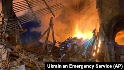 In this photo provided by the Ukrainian Emergency Service, rescuers work at the scene of a building damaged by shelling in Zaporizhzhia, Ukraine, Oct. 6, 2022.