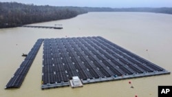 FILE - Solar panels are installed at a floating photovoltaic plant on a lake in Haltern, Germany, April 1, 2022.