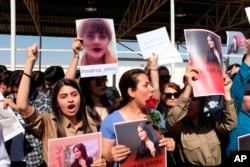 FILE - Protesters gather outside the UN headquarters in Erbil on Sept. 24, 2022, to protest the death of Masha Amini, who had fallen into a coma for three days after being detained by the morality police in Tehran, Iran.