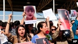 FILE - Protesters gather outside the UN headquarters in Erbil on Sept. 24, 2022, to protest the death of Masha Amini, who had fallen into a coma for three days after being detained by the morality police in Tehran, Iran.