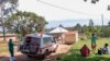 FILE - A medical officer from the Uganda Red Cross Society instructs people with suspected Ebola symptoms to enter an ambulance, near Mubende, in Uganda, Sept. 29, 2022.
