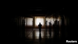 A maternity hospital employee brings meals provided by the NGO World Central Kitchen, to patients during an electricity power cut due to a Russian missile attack, in Mykolaiv, Ukraine, Oct. 22, 2022.