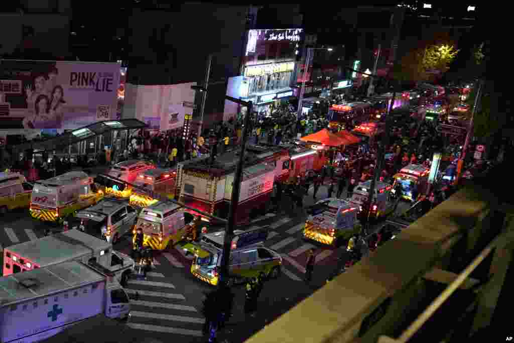 Ambulances and rescue workers arrive near the scene in Seoul, South Korea, Oct. 30, 2022. 
