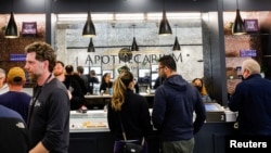 FILE - People buy recreational marijuana at the Apothecarium marijuana dispensary on the first day recreational sales are allowed for customers over the age of 21, in Maplewood, New Jersey, April 21, 2022.