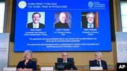 The Nobel Committee for Physics announce the winner of the 2022 Nobel Prize in Physics, from left to right on the screen, Alain Aspect, John F. Clauser and Anton Zeilinger on Tuesday, Oct. 4, 2022. (Jonas Ekstromer /TT News Agency via AP)
