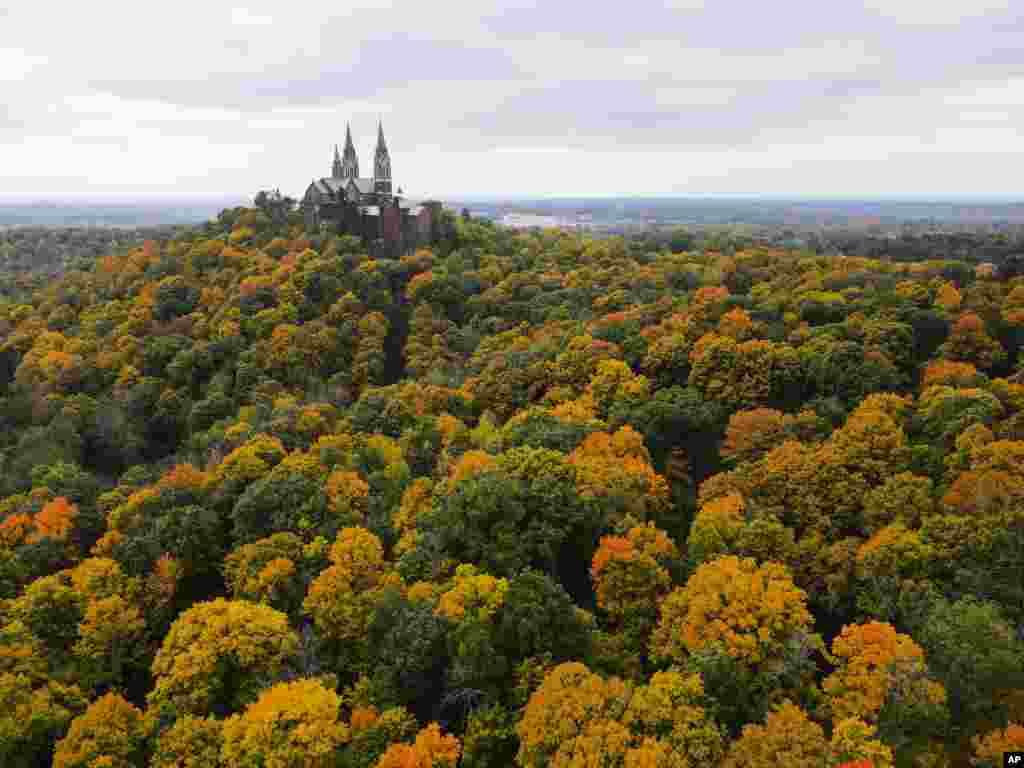 This image taken with a drone shows the trees around Holy Hill Basilica beginning to change colors, Oct. 11, 2022, in Hubertus, Wisconsin.