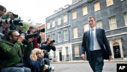 FILE - Jeremy Hunt leaves 10 Downing Street in London after he was appointed Chancellor of the Exchequer following the resignation of Kwasi Kwarteng, Oct. 14, 2022. 