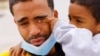 Saul, 4, wipes the tears of his father Franklin Pajaro, after they were expelled from the U.S. and sent back to Mexico under Title 42, near the Paso del Norte International border bridge, in Ciudad Juarez, Mexico, Oct. 17, 2022. 