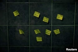FILE - Post-it Notes to learn Spanish words hang from the kitchen wall of the flat where Ukrainian refugee Tatyana Bogkova lives in Madrid, Spain, Sept. 17, 2022.