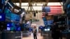 FILE - Traders work on the floor at the New York Stock Exchange in New York, on Aug. 10, 2022. 