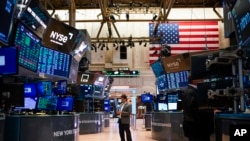 FILE - Traders work on the floor at the New York Stock Exchange in New York, on Aug. 10, 2022. 