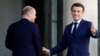 French President Emmanuel Macron welcomes German Chancellor Olaf Scholz before a meeting at the Elysee Palace in Paris, France, October 26, 2022.