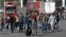 A group of Russians walk after crossing the border at Verkhny Lars between Georgia and Russia, in Georgia, Sept. 27, 2022. After President Vladimir Putin ordered a mobilization to bolster his troops in Ukraine, many Russians are leaving their homes.