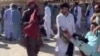 FILE - This screenshot of a video sent to VOA Persian appears to show residents of Zahedan, Iran, carrying a man with bloodstained clothing, Sept. 30, 2022. Human rights groups said 66 civilians were slain and scores were injured inside and outside a mosque in the city. (UGC)