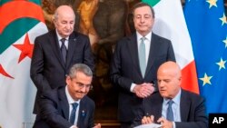 FILE - Italian Prime Minister Mario Draghi, Algerian President Abdelmadjid Tebboune signing a gas agreement in Rome, May 26, 2022.