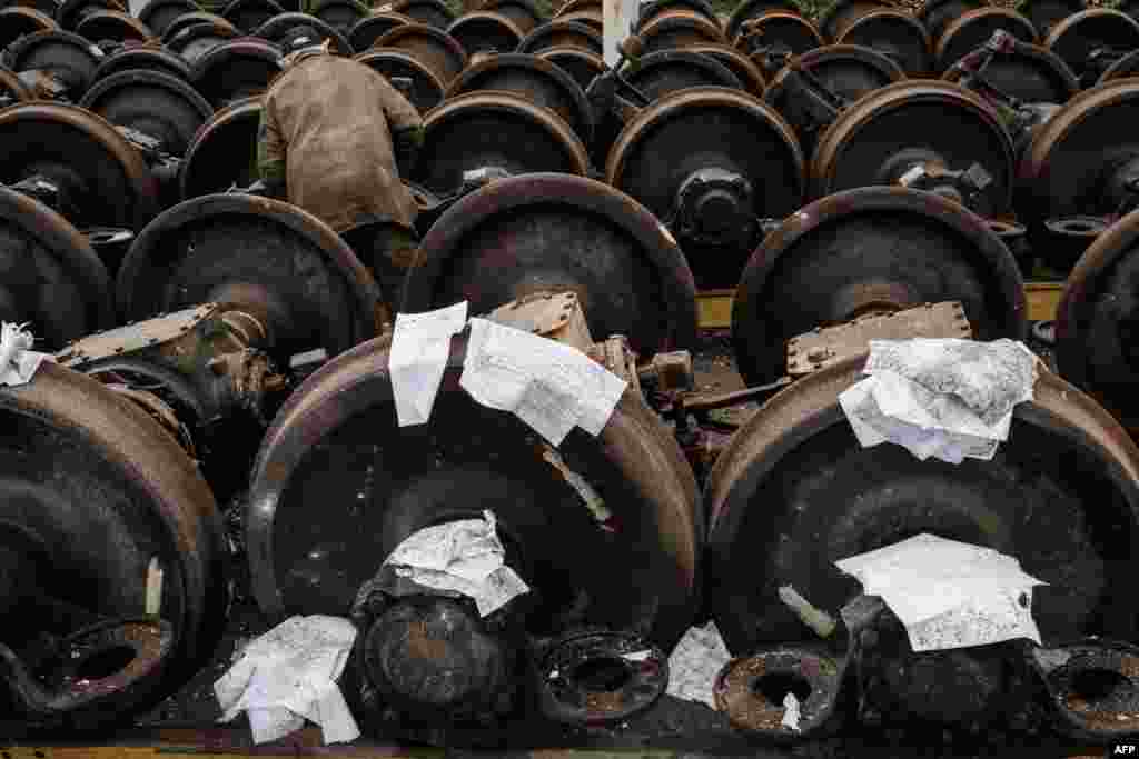 Wet documents are put on train wheels to dry near a railway yard of the freight railway station in Kharkiv, which was partially destroyed by a missile strike, amid the Russian invasion of Ukraine.