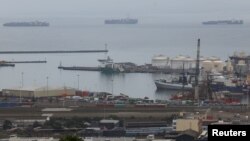 FILE - Container ships are seen outside the harbour as workers at South Africa's state-owned logistics firm Transnet continue to protest outside the Port of Cape Town on their nationwide strike action, in Cape Town, Oct. 17, 2022.