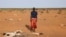 FILE - An internally displaced Somali man looks at the carcass of his dead livestock following severe droughts near Dollow, Gedo Region, Somalia May 26, 2022.