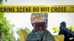 A mother of one of the children cries at the scene of a fire, at the Salama School for the Blind in Luga village, Mukono district, Uganda, Oct. 25, 2022. 