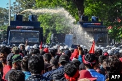 FILE - Police use water cannons to disperse anti-government protesters during a demonstration in Colombo, Sri Lanka, Sept. 24, 2022.