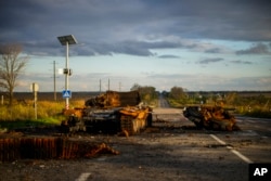 Remains of a destroyed Russian tank are scattered on the ground along the road between Izium and Kharkiv, Ukraine, Monday, Oct. 3, 2022. (AP Photo/Francisco Seco)