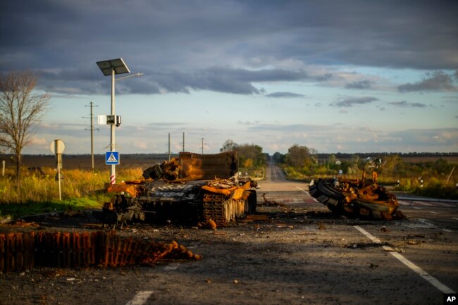 Remains of a destroyed Russian tank are scattered on the ground along the road between Izium and Kharkiv, Ukraine, Monday, Oct. 3, 2022. (AP Photo/Francisco Seco)