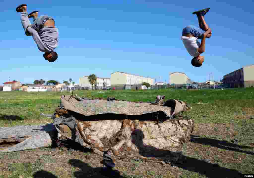 Boys play on old mattresses in Hanover Park, an area affected by ongoing gang violence in Cape Town, South Africa, Sept. 28, 2022.